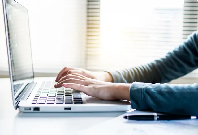 Close-up shot of hands typing on a laptop keyboard, perfect for business or technology themes. How to approach best business email software in practice